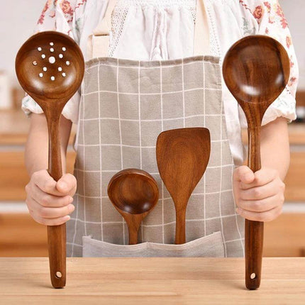 Teak Wood Kitchen Utensil Set Nonstick Pot Shovel And Spoons held by person wearing apron, 12-piece polished teak spoons and spatula gentle on nonstick cookware