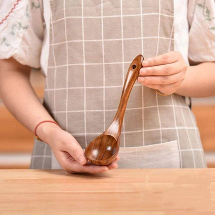 Teak Wood Kitchen Utensil Set Nonstick Pot Shovel And Spoons - polished teak rice scoop held by person in apron, safe for nonstick cookware