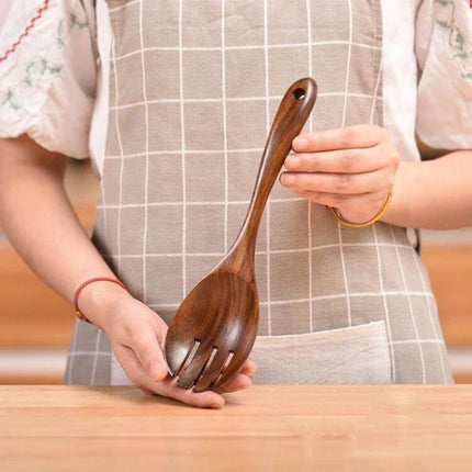 Teak Wood Kitchen Utensil Set Nonstick Pot Shovel And Spoons wooden serving spoon and fork held by person, smooth polished teak for nonstick cookware