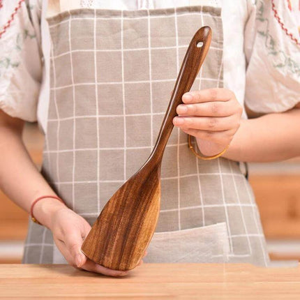 Teak Wood Kitchen Utensil Set Nonstick Pot Shovel And Spoons - polished teak cooking shovel held by person in apron, gentle on nonstick cookware