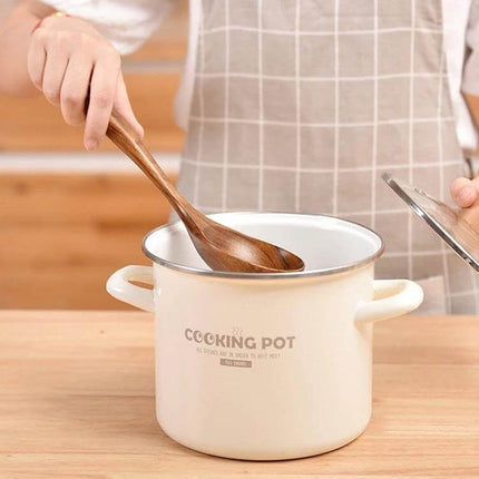 Teak Wood Kitchen Utensil Set Nonstick Pot Shovel And Spoons being used to stir a white cooking pot with a wooden spoon, smooth polished teak utensils for nonstick cookware