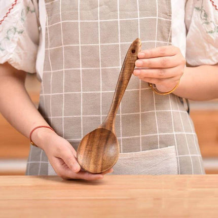 Teak Wood Kitchen Utensil Set Nonstick Pot Shovel And Spoons - polished teak serving spoon held by person in apron
