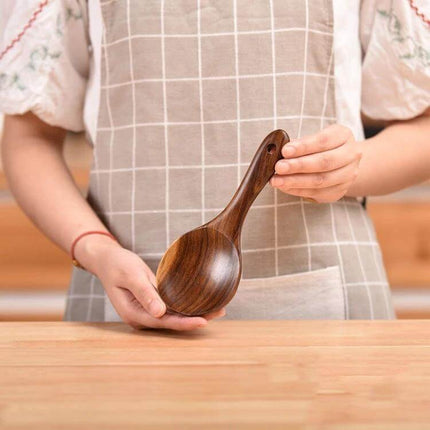 Teak Wood Kitchen Utensil Set Nonstick Pot Shovel And Spoons - polished teak rice scoop held by person in apron, gentle on nonstick cookware