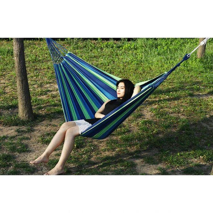 Thick Canvas Hammock For Outdoor Relaxation 260x150 blue green striped canvas hammock with person reclining in backyard