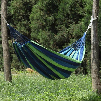 Thick Canvas Hammock For Outdoor Relaxation 260x150 hanging between trees in a green backyard setting