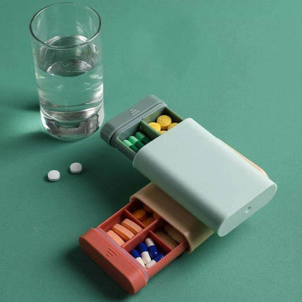 Three-Piece Portable Pill Box For Daily Use Ideal For Home Or Travel - compact ABS plastic organizer with removable divider and pull-out lid, shown with pills and glass of water