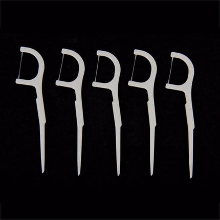 Tooth Pick With Thread, Wide ABS Dental Floss, 50 Pack - five white ABS floss picks on black background for interdental cleaning