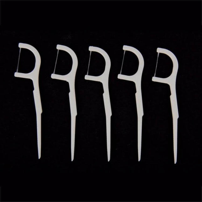 Tooth Pick With Thread, Wide ABS Dental Floss, 50 Pack - five white ABS floss picks on black background for interdental cleaning