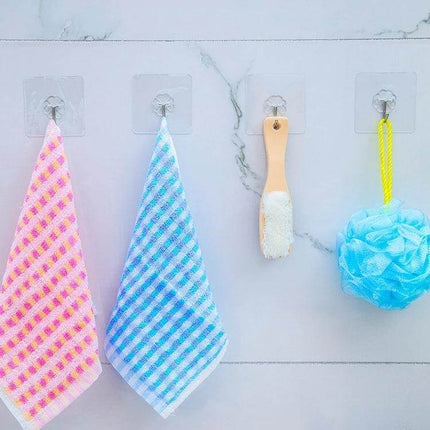 Transparent Plum-Shaped Adhesive Hooks for Kitchen, 10-Pack holding towels, brush and loofah on a smooth tiled backsplash