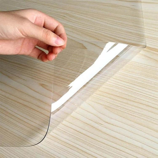 Transparent Soft Glass Tablecloth, Waterproof 90x120 on wood table showing clear protective PVC cover being lifted