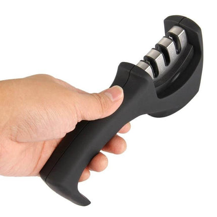 Tungsten Steel Knife Sharpener With Curved Handle For Kitchen Use in hand showing 3-step ceramic, coarse and fine slots for everyday knife maintenance