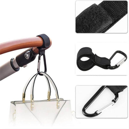 Two Pack Baby Stroller Carabiner Hooks, Brown and Black - leather strap and metal carabiner holding a handbag on stroller handle