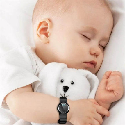 Ultrasonic Mosquito Repellent Bracelet Black Everyday Use worn on baby’s wrist next to plush toy, compact lightweight 45g wearable for comfortable everyday protection