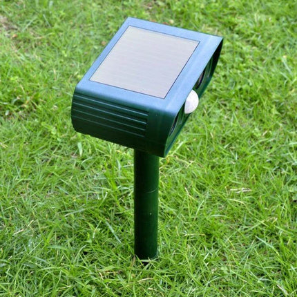Ultrasonic Solar-Powered Animal Repeller, 2-Pack for Gardens inserted in lawn near border with solar panel and PIR sensor