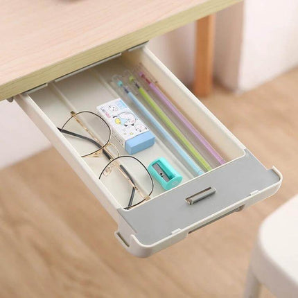 Under Desk Drawer Storage Box With Pull Out Pen Storage holding glasses, pencils, eraser and sharpener in a concealed under-desk slide-out tray
