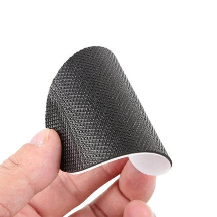 Unisex Anti-Slip Sole Protector Pads For Shoes Self-Adhesive black rubber textured self-adhesive pad held between fingers