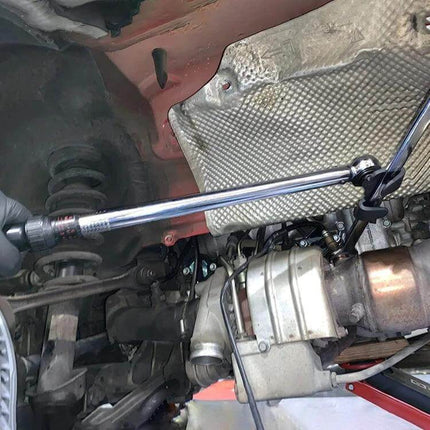 Universal Hex Wrench Extender Adapter for Half-Inch or 21mm Hex Drivers installed on vehicle undercarriage extending reach and torque