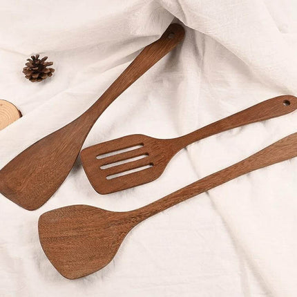 Unpainted Wooden Spatula Set, Long-Handle Utensils – three perforated and solid natural wood cooking spatulas on a white cloth background