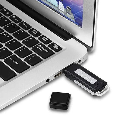 SK868 Rechargeable Voice Recorder for Travel and Daily Notes plugged into laptop USB port, compact black recorder with cap removed
