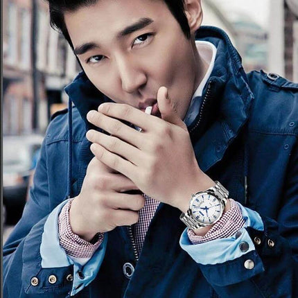 SKMEI Silver Waterproof Quartz Wrist Watch for Everyday Outdoor Activities on a man wearing a navy jacket with luminous hands visible