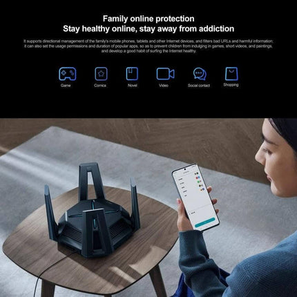 Xiaomi Tri-Band WiFi Router for Home Network Connectivity on table with person controlling settings via smartphone