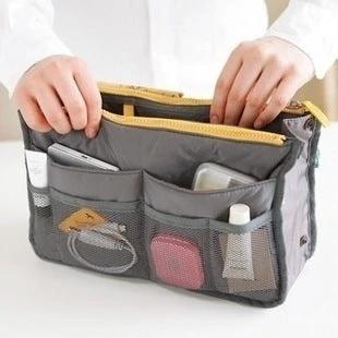 Waterproof Folding Travel Bag Large Capacity for Sundries shown packed with toiletries, cosmetics, cables and organized pockets