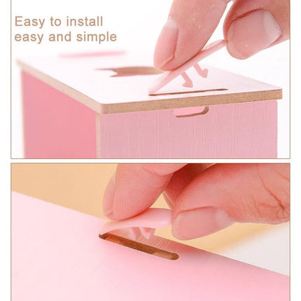 Wooden 30-Grid Phone Display Stand for Desktop, Black showing finger inserting peg into slot during easy assembly demonstration