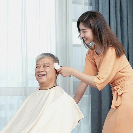 Xiaomi Enchen Boost Hair Trimmer With Fast Charging For Home Haircuts used by woman to trim older man’s neckline and ears, cordless quick-charge grooming