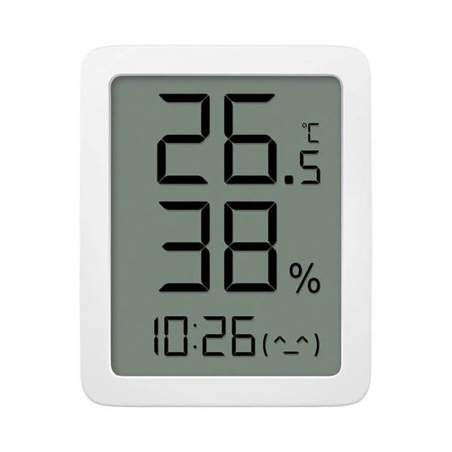 Xiaomi Youpin Miaomiaoce LCD Hygrometer to Monitor Indoor Humidity showing 26.5°C, 38% RH and digital clock on white LCD display