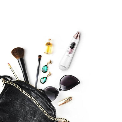 Xpreen Pore Cleanser For Home Facial With LED Screen shown with makeup brushes, sunglasses, perfume and accessories for travel-ready skincare