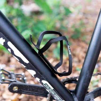 ZTTO Aluminum Bicycle Water Bottle Cage Ultralight Holder mounted on black mountain bike frame, secure lightweight aluminum bottle cage