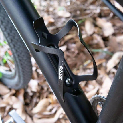 ZTTO Aluminum Bicycle Water Bottle Cage Ultralight Holder mounted on mountain bike frame, lightweight aluminum bottle cage securing hydration