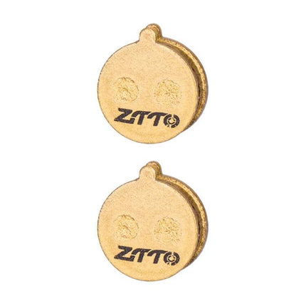 ZTTO Mountain Bike Brake Pads Full Metal Copper Base showing two round copper-backed brake pads for mountain and urban trail use
