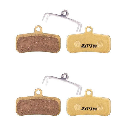 ZTTO Mountain Bike Brake Pads Full Metal Copper Base shown as four copper-based brake pads with anti-rattle springs, durable low-noise design for trails