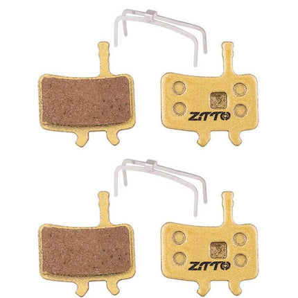 ZTTO Mountain Bike Brake Pads Full Metal Copper Base shown as four copper-backed pads with anti-rattle springs for quiet, durable trail braking