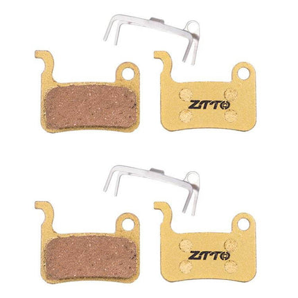 ZTTO Mountain Bike Brake Pads Full Metal Copper Base shown as two pairs of copper-backed brake pads with retention springs