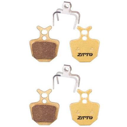 ZTTO Mountain Bike Brake Pads Full Metal Copper Base close-up of four copper-base pads and springs, low-noise durable performance for trail riding