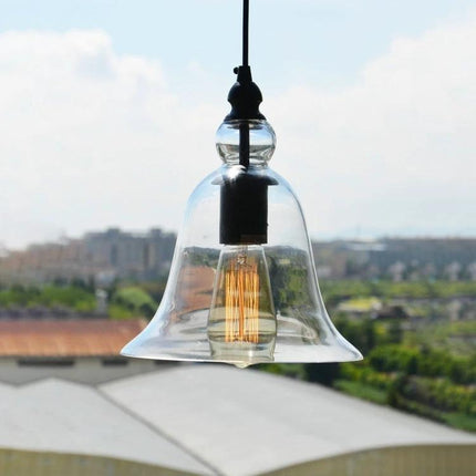 Glass Pendant Light for Kitchen and Dining Rooms at Home with clear bell-shaped glass shade over a dining table or kitchen island