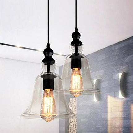 Glass Pendant Light for Kitchen and Dining Rooms at Home - clear bell-shaped retro glass pendant over kitchen island with warm filament bulbs