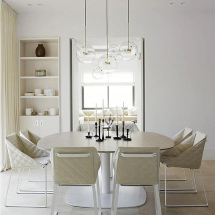 Stylish Glass Ball Chandelier for Everyday Home Lighting hanging above a minimalist dining table in a neutral modern interior