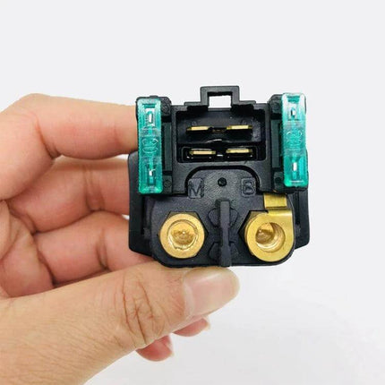 Yamaha Starter Relay Solenoid Kit With Fuses For Motorcycles in hand showing copper relay posts and dual fuses