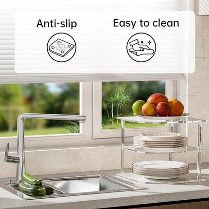 Acrylic 3 Tier Corner Plates and Bowls Organizer Shelf on kitchen countertop by sink, anti-slip clear acrylic organizer with stacked plates and fruit