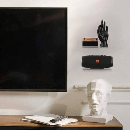 Acrylic Wall Hanger for Small Speakers and Phones at Home holding a wireless speaker and phone on a minimalist living room wall