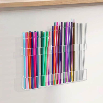 Acrylic Straw Wall Mount Bracket With Double-Sided Adhesion holding colorful reusable straws on a kitchen wall for compact, tool-free storage