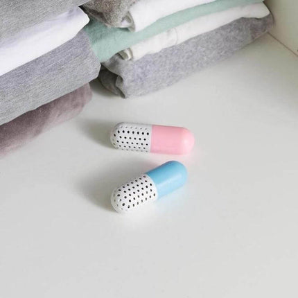 Alloet Shoe Deodorizer Capsules For Shoes And Closet Freshness - pink and blue capsules next to folded clothes for closet and drawer odor control