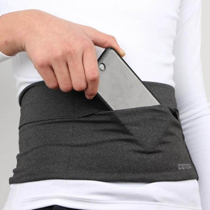 Anti Theft Travel Bag With Tablet Pockets Size L Everyday Use showing person placing phone in waistband tablet pocket for secure everyday carry