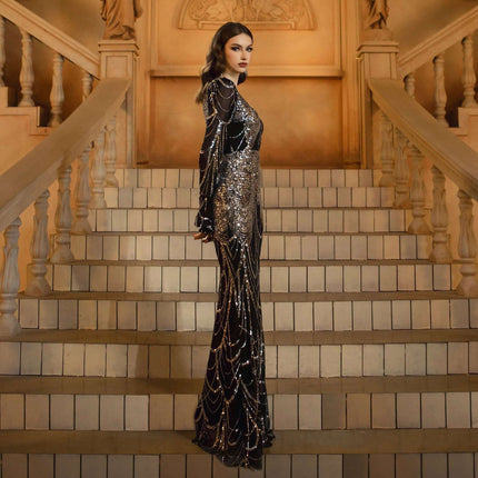 Sequined Evening Dress For Formal Events, Black Silver model in long high-waist sequined gown with long sleeves on grand staircase