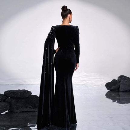 Black Velvet Round Neck Long Sleeve Rhinestone Evening Dress on model back view, velvet fabric, subtle rhinestone detailing and long draped sleeve.