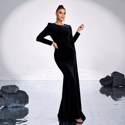Black Velvet Round Neck Long Sleeve Rhinestone Evening Dress modeled in fitted black velvet with subtle rhinestone shoulder detail