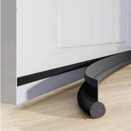Door Bottom Seal Strip Brown Self Adhesive Gap Sealing for Doors shown installed under a white door, brown EPE foam with non-woven fabric backing